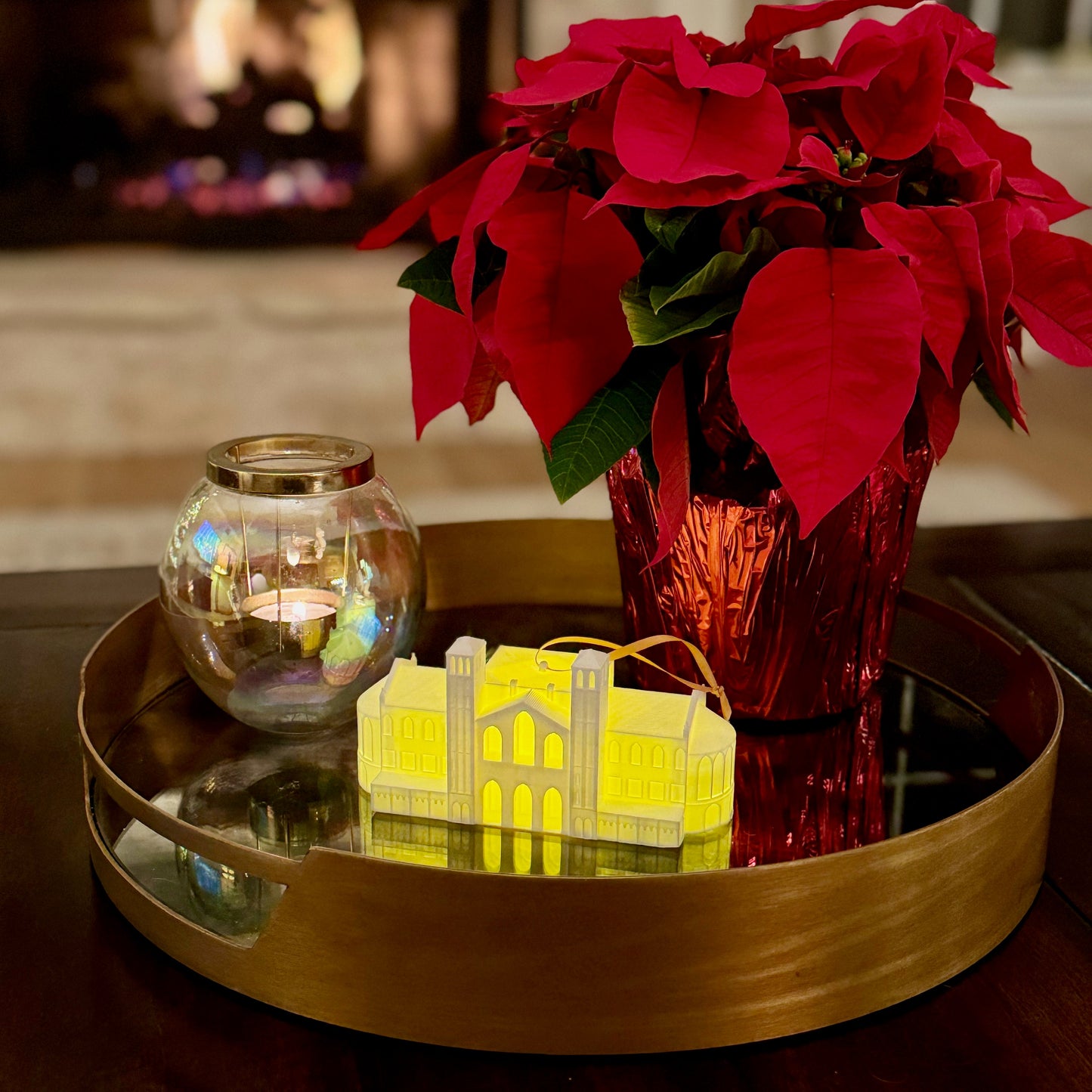 The UCLA keepsake ornament of Royce Hall, shown in a home decorated for the holidays.