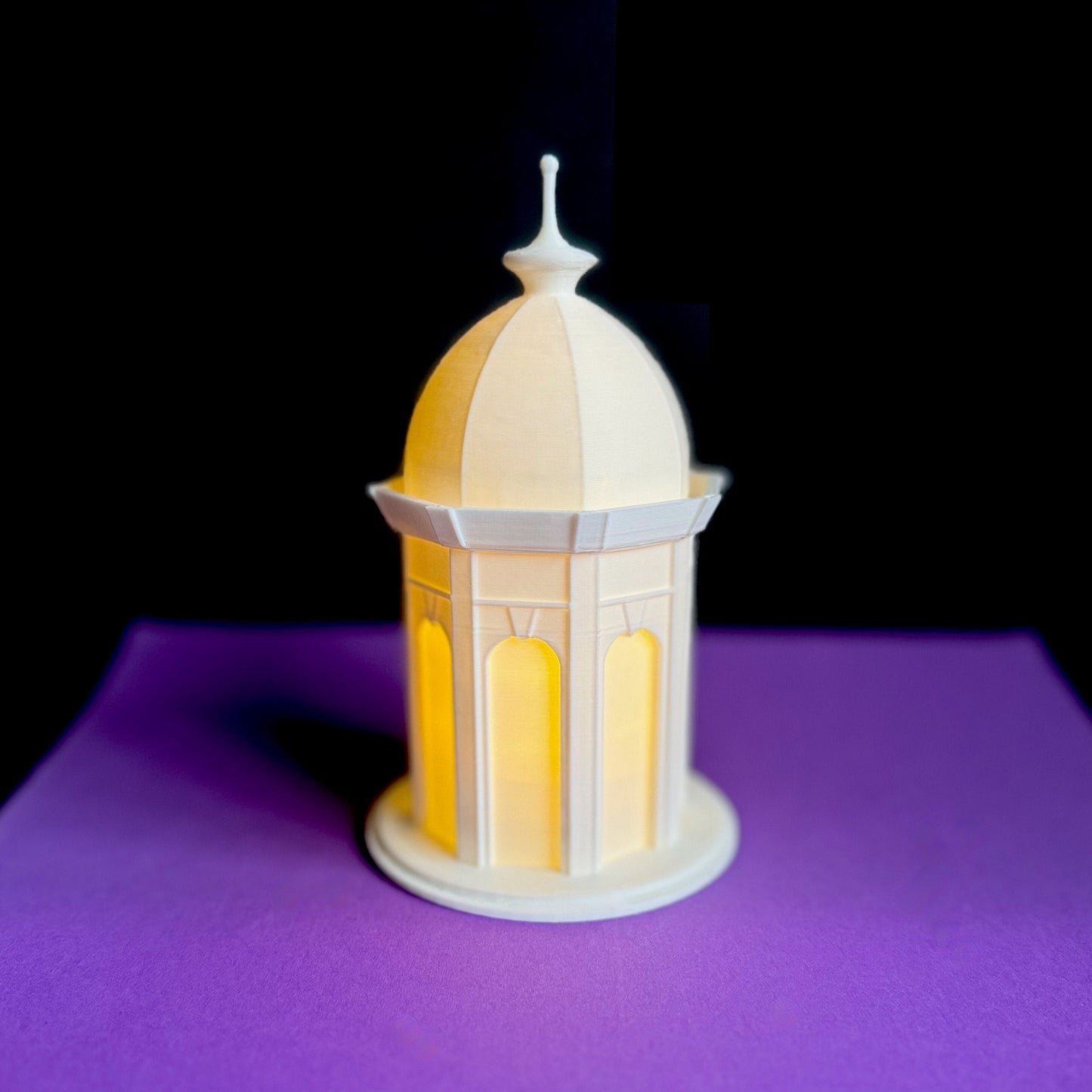 The lighted ECU Cupola figurine, shown against a purple background.