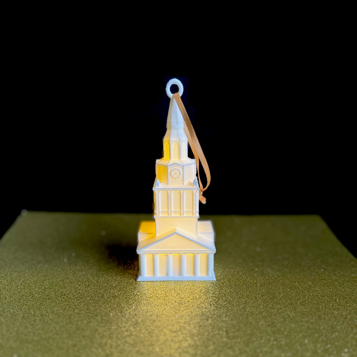 The Wake Forest Wait Chapel ornament, shown with a soft white light.