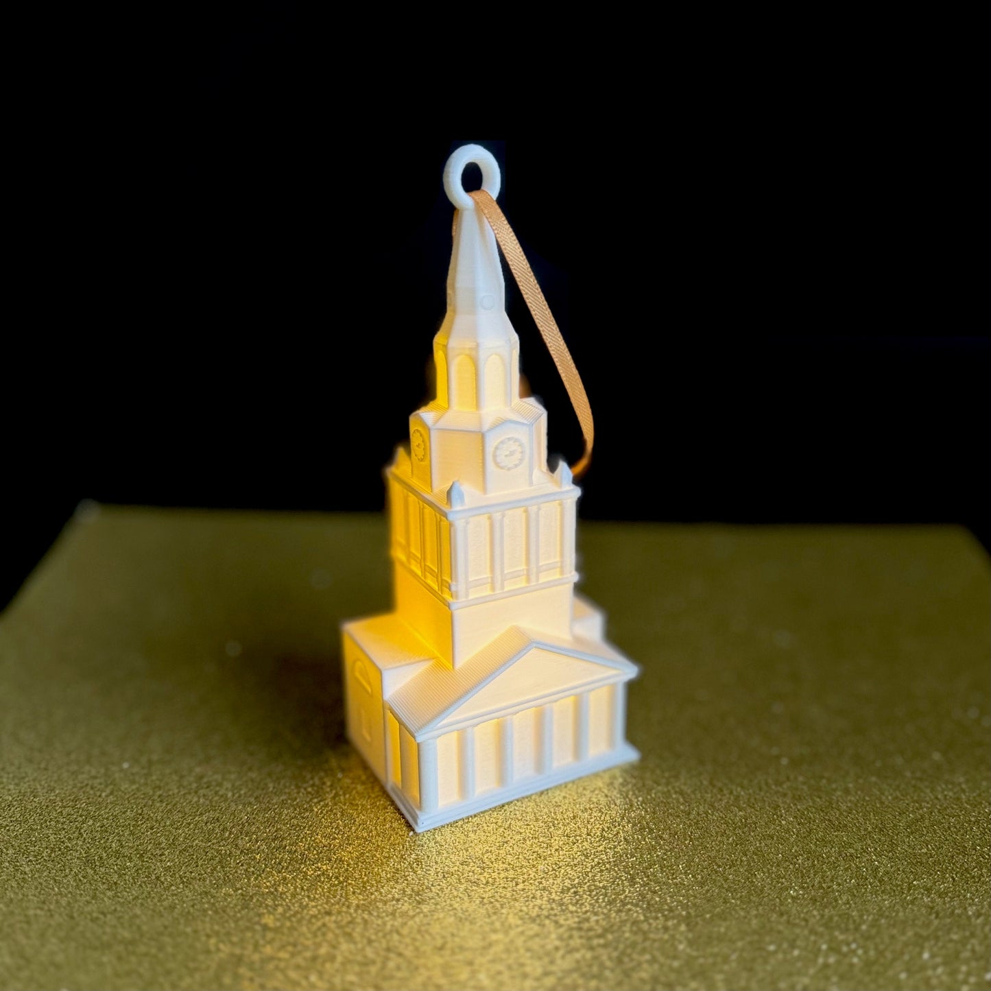 The Wake Forest Christmas decoration, shown against a gold background.